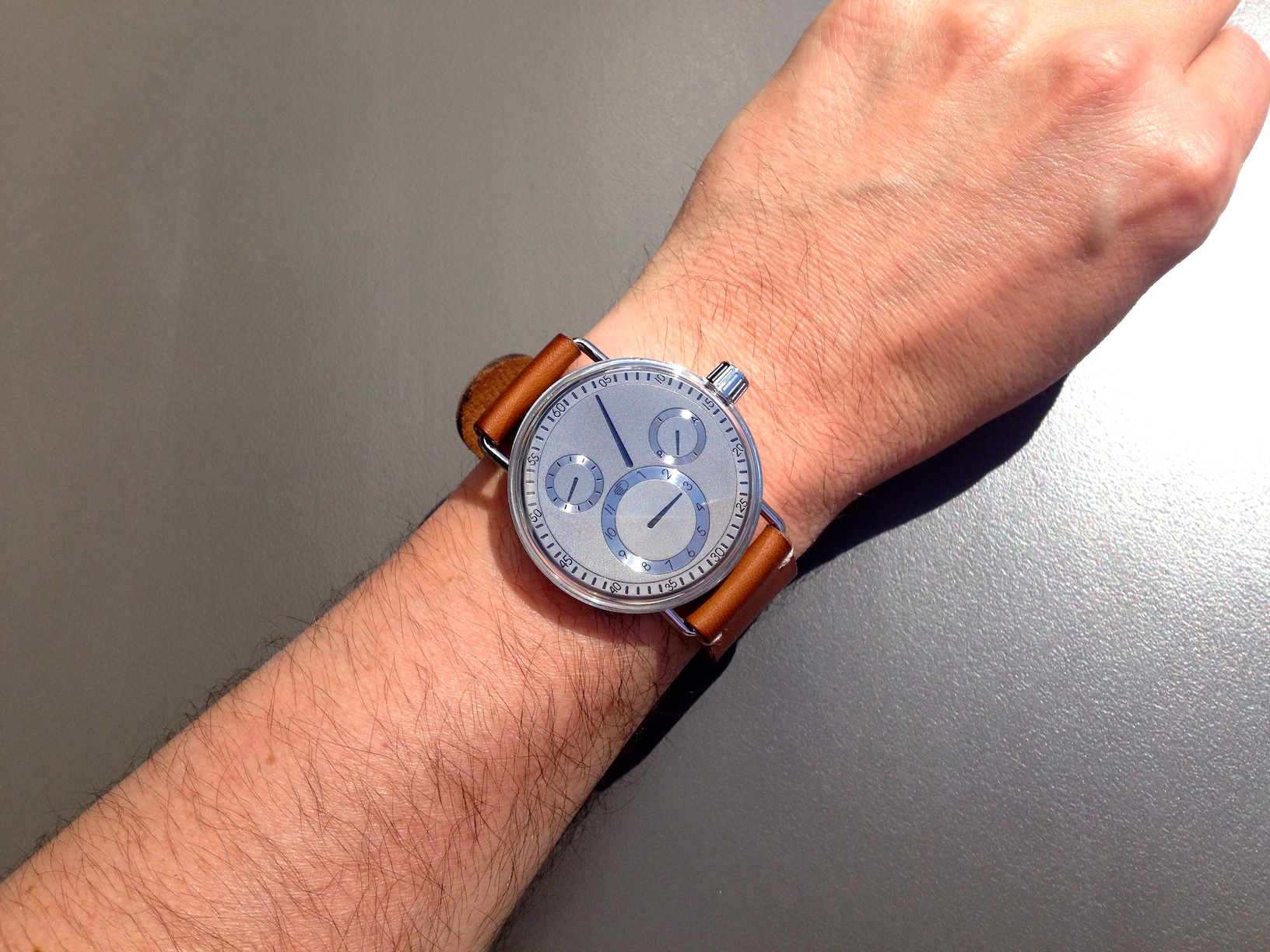 Side view of a Ressence SeriesOne wristwatch showing the case profile and lug area