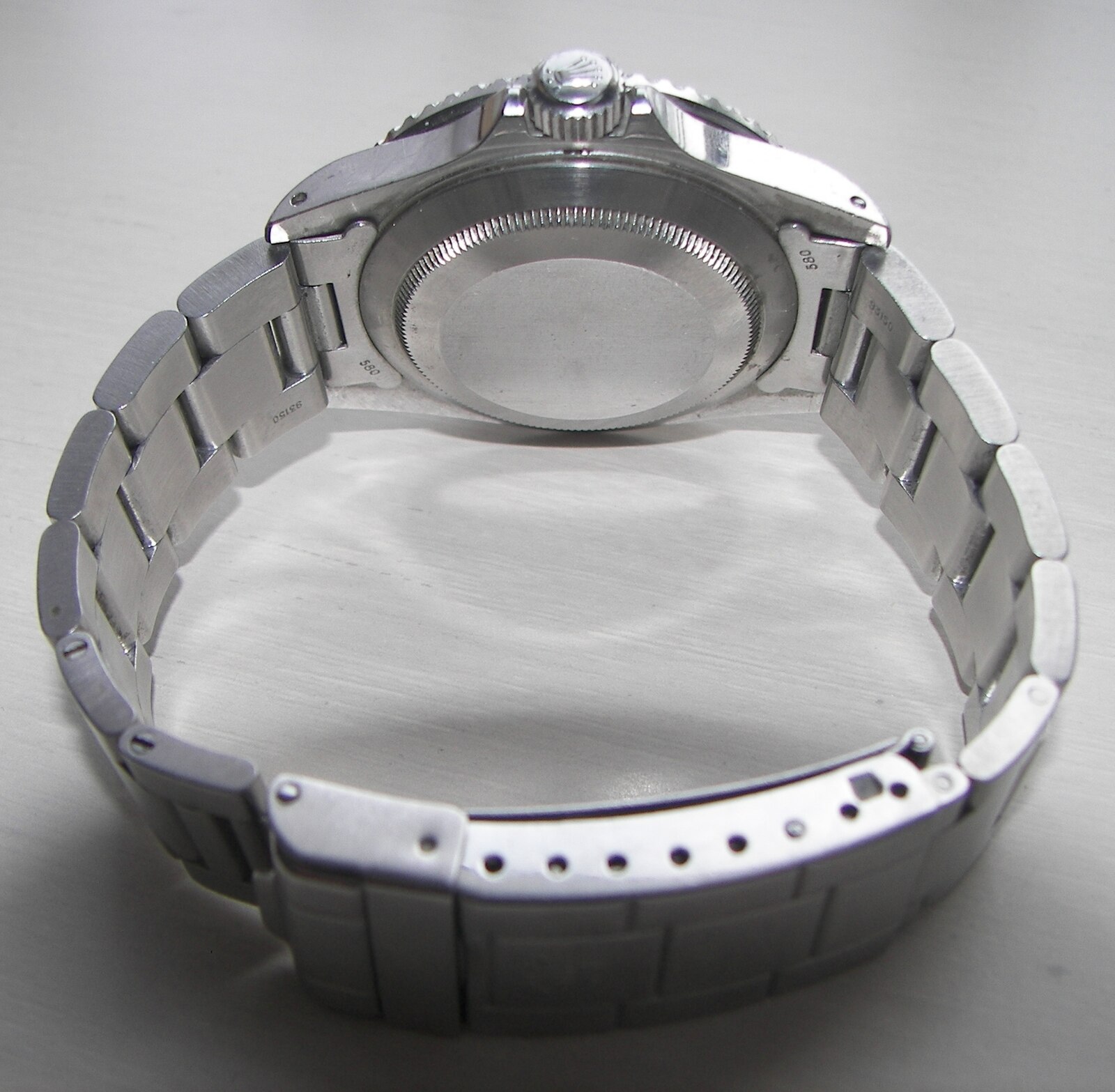 Smooth stainless-steel caseback of a Rolex Submariner