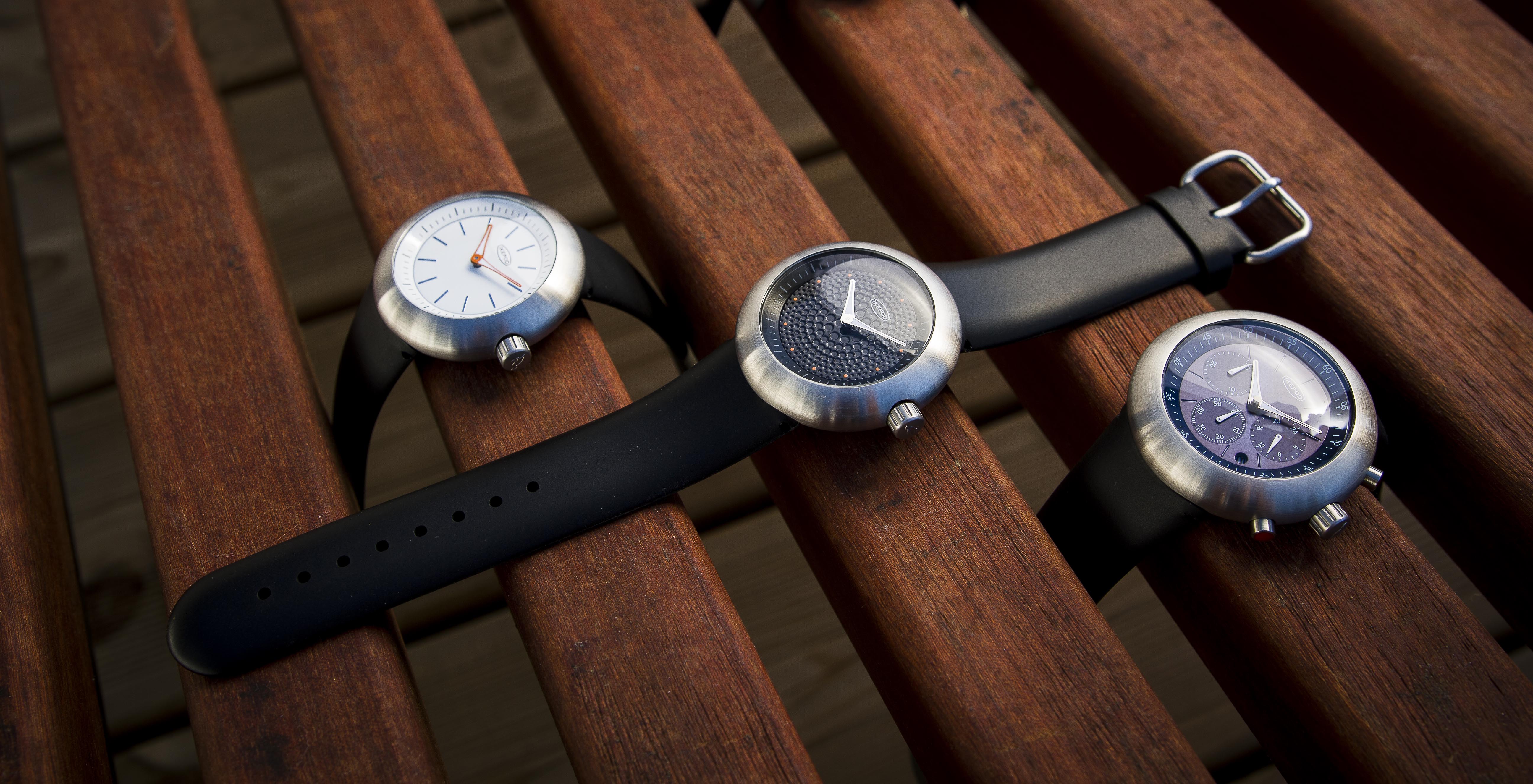 Three modern Ikepod wristwatches arranged side by side for comparison