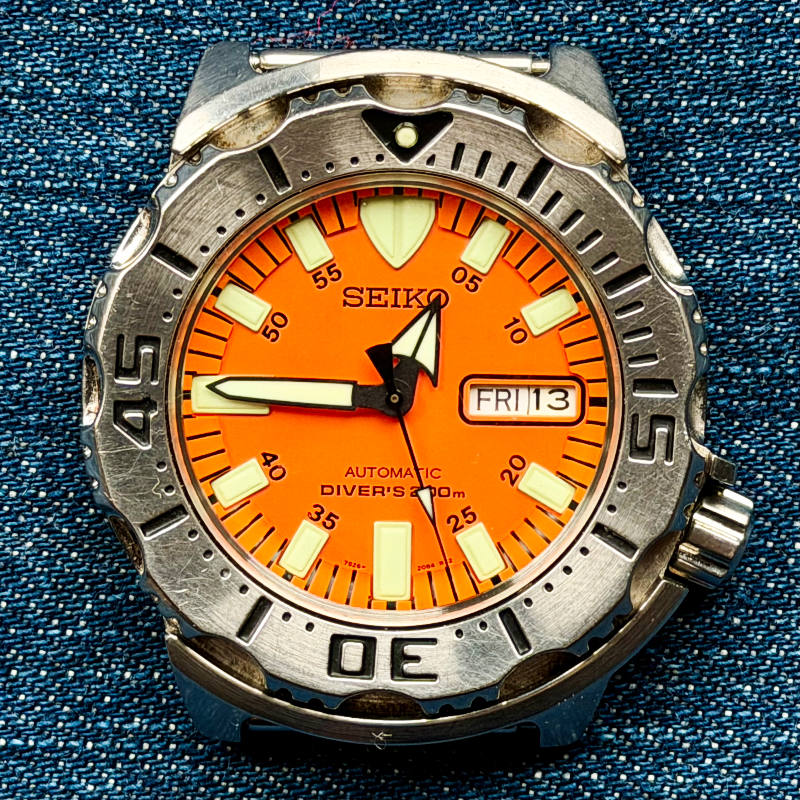 Close-up of a Seiko Orange Monster dive watch dial showing brand signature, indices, and hands